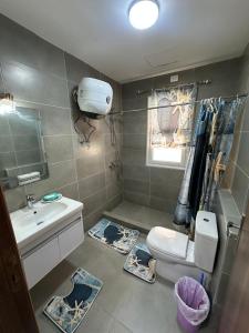 a bathroom with a toilet and a sink at AMWAj in El Alamein