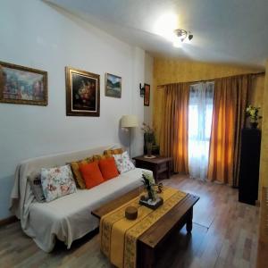a living room with a couch and a table at Alborada in Pinos Genil