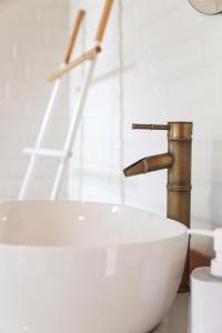 a bathroom with a sink and a faucet at Markisa Villas - Spacious Private Pool Homes on Gili Air in Gili Islands