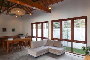 a living room with a couch and a table at Markisa Villas - Spacious Private Pool Homes on Gili Air in Gili Islands +65 photos