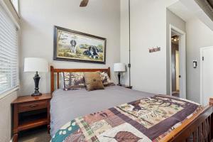 a bedroom with a bed and a picture on the wall at Bass Lake Lodge in Bass Lake