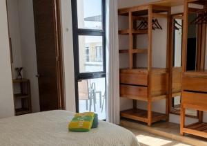 a bedroom with a bed and a book shelf at Telchac 3 bedrooms, pool and beach in Telchac Puerto +16 photos