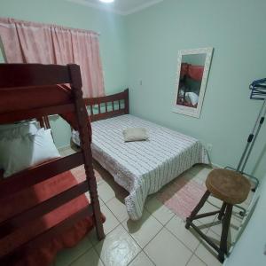 a small bedroom with a bed and a mirror at Gourmet space in São Paulo