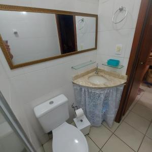 a bathroom with a sink and a toilet and a mirror at Gourmet space in São Paulo +22 photos