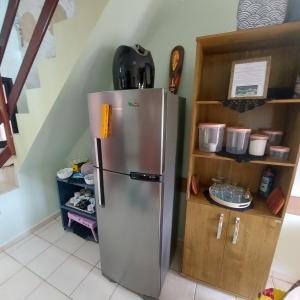 a stainless steel refrigerator in a kitchen next to a staircase at Gourmet space in São Paulo