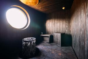 a room with a round window and a wooden wall at abrAsus house Fuji in Narusawa