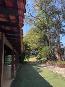 a building with a green floor next to some trees at Quarto suíte privativo em campinas para 4 pessoas in Campinas