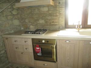 a kitchen with a stove top oven next to a sink at Residenza Sant'Antonio in Deliceto