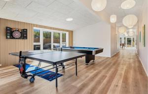 a room with a ping pong table in it at Beautiful Home In Ejstrupholm in Krejbjerg +24 photos