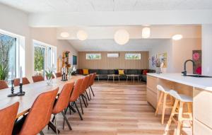 a waiting room with a long table and chairs at Beautiful Home In Ejstrupholm in Krejbjerg