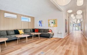a living room with a couch and two tables at Beautiful Home In Ejstrupholm in Krejbjerg