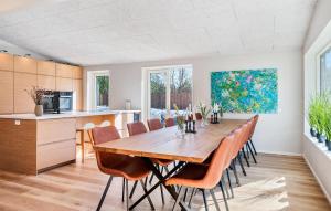 a kitchen and dining room with a wooden table and chairs at Beautiful Home In Ejstrupholm in Krejbjerg