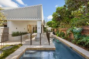a home with a swimming pool in front of a house at Villa Alcorn in Suffolk Park