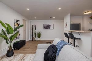 a living room with a couch and a table at Inlet View Luxe -King Suite - Downtown Anchorage in Anchorage