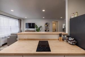 a kitchen with a counter top with a stove at Inlet View Luxe -King Suite - Downtown Anchorage in Anchorage
