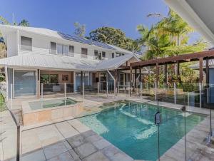an exterior view of a house with a swimming pool at Macadamia Ocean Escape in Pottsville