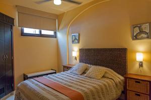a bedroom with a large bed with two pillows at Beach Break Suites Sayulita in Sayulita +47 photos