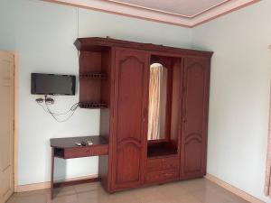 a wooden cabinet in a room with a table at D Cunhas Riviera in Cochin