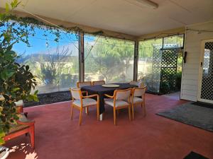 a dining room with a table and chairs on a patio at Hopetoun - footprints in the sand in Hopetoun