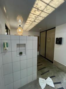 a room with a white tiled wall in a building at Ávita Lodge in Quesada +73 photos