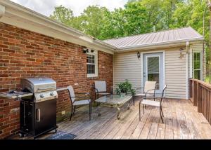 a patio with a grill and a table and chairs at Bourbon Roost in Saint Francis