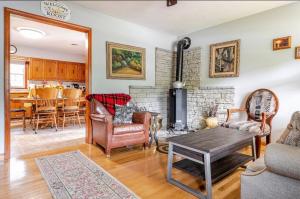 a living room with a fireplace and a table at Bourbon Roost in Saint Francis