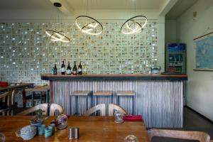 a dining room with a table and a bar at Amazing Lombok Resort in Selong Belanak