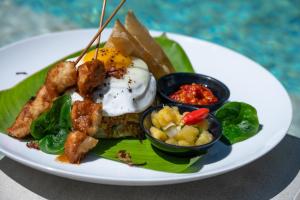 a plate of food with an egg on a banana leaf at Amazing Lombok Resort in Selong Belanak +19 photos