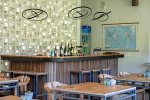 a bar in a restaurant with tables and bottles of wine at Amazing Lombok Resort in Selong Belanak