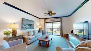 a living room with a couch and a table at 240 Captains Quarters in Hilton Head Island