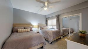a bedroom with two beds and a ceiling fan at 240 Captains Quarters in Hilton Head Island