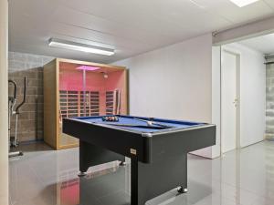 a pool table in the middle of a room at Luxury Country House with Pool in Manhay