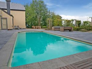 a swimming pool in the backyard of a house at Luxury Country House with Pool in Manhay