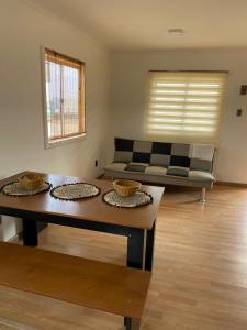 a living room with a couch and a table at Cabañas CR guanaqueros in Coquimbo