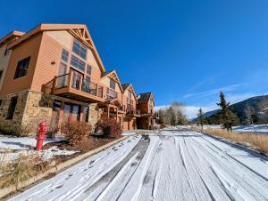 a house in the snow with a red fire hydrant at Antlers Gulch 501 by SummitCove Lodging in Colorado in Keystone