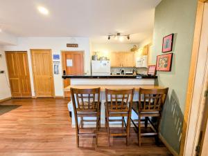 a kitchen with a table and four chairs and a counter at Gateway Lodge 5030 by SummitCove Lodging in Colorado in Keystone