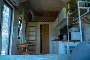 a tiny house with a kitchen and a bedroom at Il Nostro Sogno - Madonna by Tiny Away in San Michele Salentino