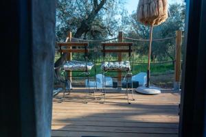 a group of chairs sitting on a deck at Il Nostro Sogno - Madonna by Tiny Away in San Michele Salentino