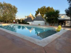a swimming pool with its reflection in the water at Il Nostro Sogno - Madonna by Tiny Away in San Michele Salentino