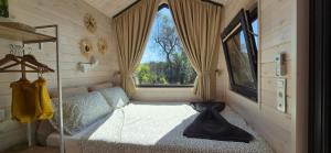 a bedroom with a bed and a large window at Il Nostro Sogno - Madonna by Tiny Away in San Michele Salentino