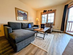 a living room with a couch and a table at Expedition Station 8622 by SummitCove Lodging in Colorado in Keystone