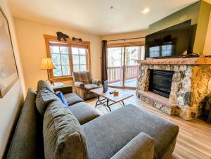 a living room with a couch and a fireplace at Expedition Station 8622 by SummitCove Lodging in Colorado in Keystone