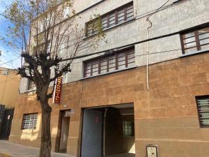 a building with a tree in front of it at Imperio Carlos V in Oruro