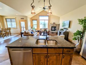a kitchen with a sink and a living room at Frey Gulch 58 by SummitCove Lodging in Colorado in Keystone