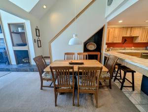 a dining room with a wooden table and chairs at Pines 2129 by SummitCove Lodging in Colorado in Keystone