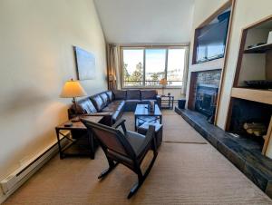 a living room with a couch and a fireplace at Pines 2129 by SummitCove Lodging in Colorado in Keystone