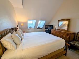 a bedroom with a bed and a mirror and a television at Pines 2129 by SummitCove Lodging in Colorado in Keystone +66 photos
