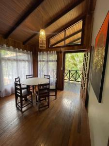 a dining room with a table and chairs at Ávita Lodge in Quesada
