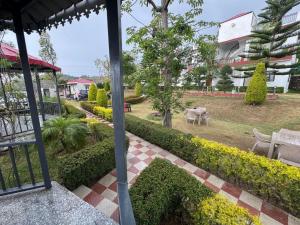 a view of a garden from the balcony of a house at Mohdev Resort in Lakhwār