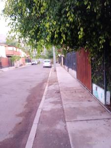 a sidewalk with a car parked on the side of a street at Valle de Elqui in Vicuña